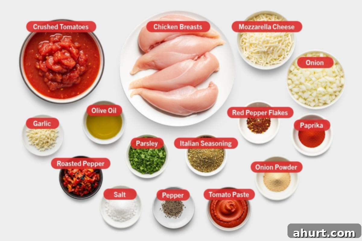 Golden Mozzarella Chicken Bake 3 Top shot of all ingredients for Easy Mozzarella Chicken, including crushed tomatoes, chicken breasts, mozzarella cheese, onion, garlic, olive oil, roasted pepper, salt, fresh parsley, black pepper, Italian seasoning, tomato paste, red pepper flakes, onion powder, and paprika.