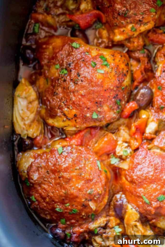 Cooked Slow Cooker Mediterranean Chicken with olives and artichokes, ready to be served from the slow cooker.