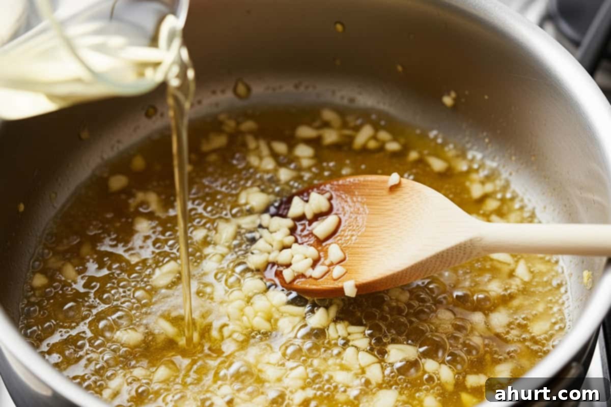 Succulent Broiled Lobster Tails 6 Garlic with melted butter in a saucepan with spoon and poured white wine.