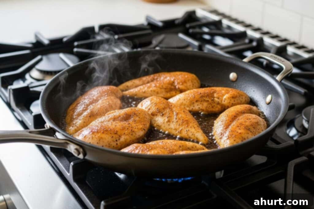 Decadent Tuscan Chicken 5 Step 2: Searing seasoned chicken in a hot skillet until golden