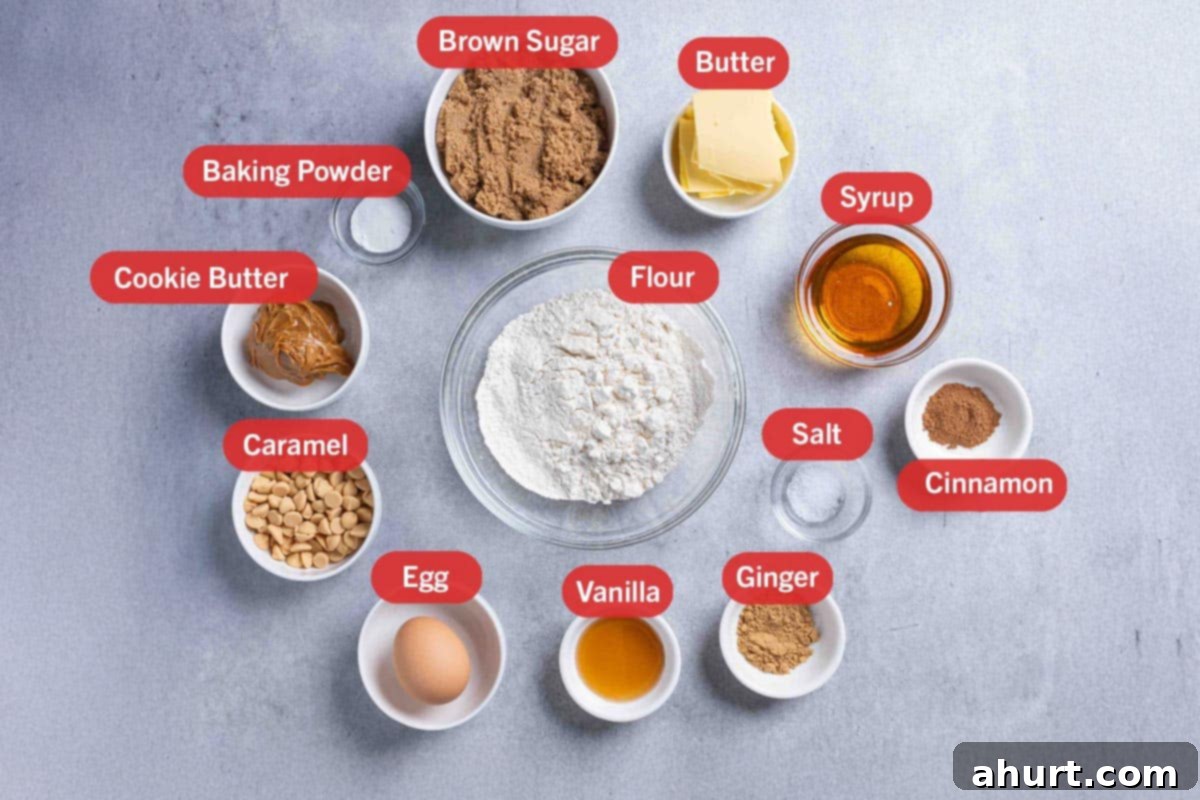Luxurious White Chocolate Blondie Delights 3 Photo of the ingredients needed for the White Chocolate Blondies: brown sugar, butter, syrup, cinnamon, salt, ginger, vanilla, egg, white chocolate or caramel chips, cookie butter, and baking powder.