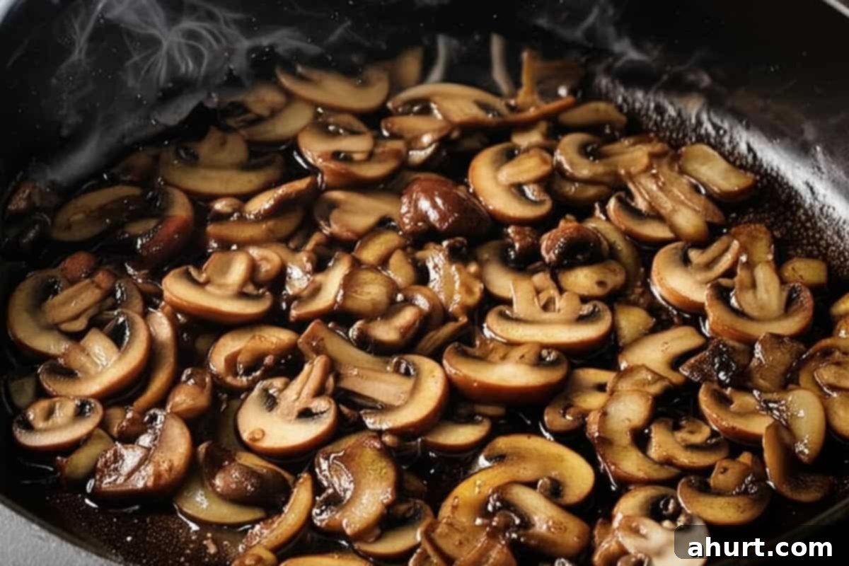 Savory Steaks with Velvety Mushroom Gravy 7 Cooking brown mushrooms in a skillet.