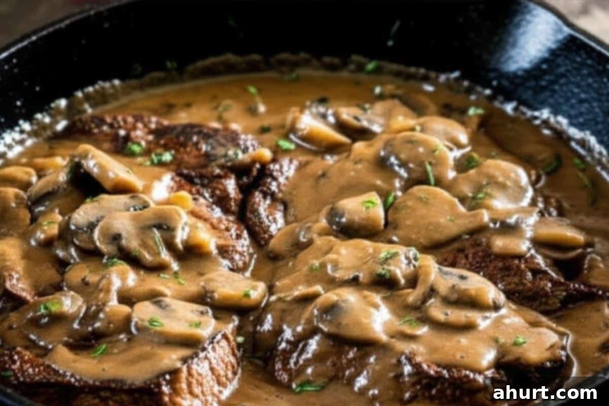 Savory Steaks with Velvety Mushroom Gravy 10 Steaks with mushroom gravy over the top.