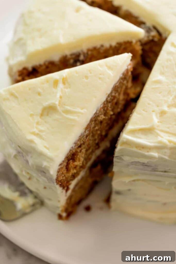 Golden Spiced Carrot Cake 2 Super soft Carrot cake cut into large triangle slices on a serving plate.