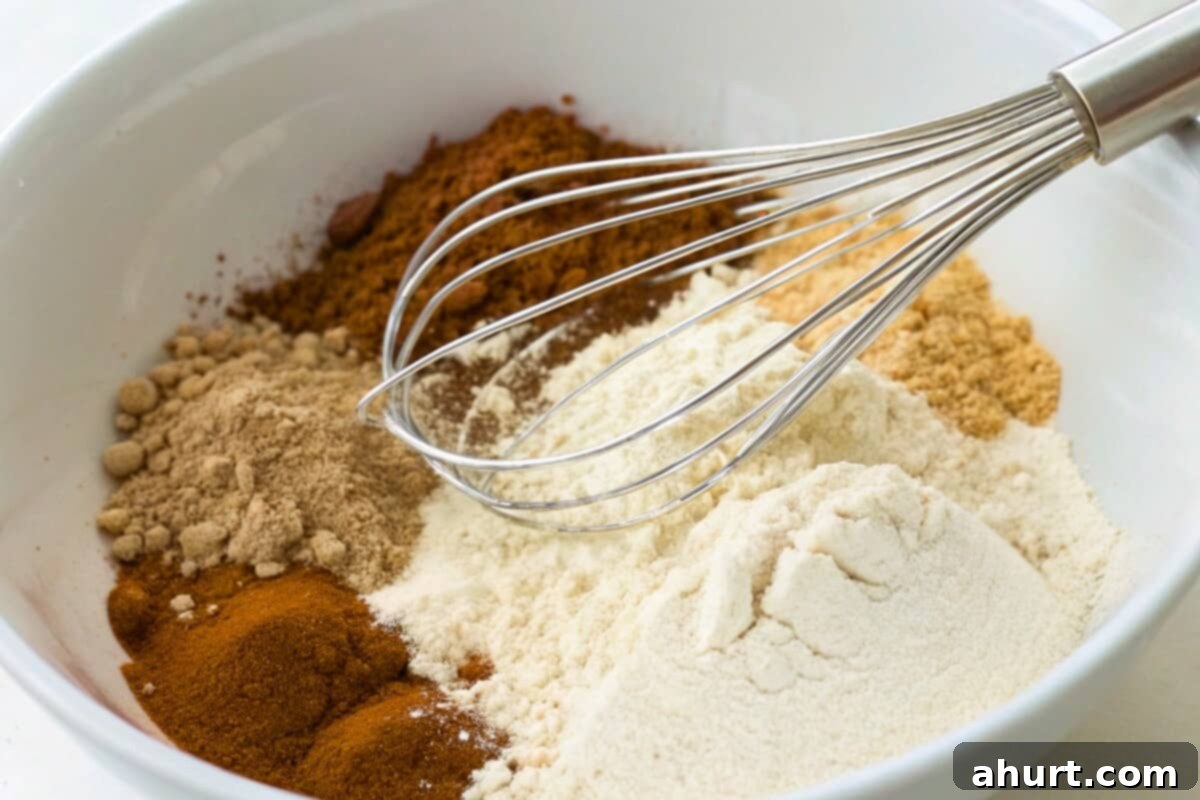 Golden Spiced Carrot Cake 5 In a bowl, whisk all the dry ingredients (flour, baking powder, baking soda, salt, cinnamon, ginger and nutmeg)