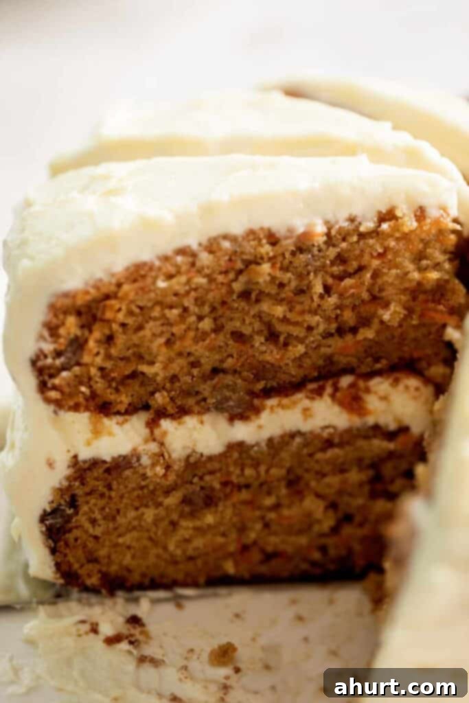 Golden Spiced Carrot Cake 10 Close up image of the inside of the cake, with thick icing between two layers.