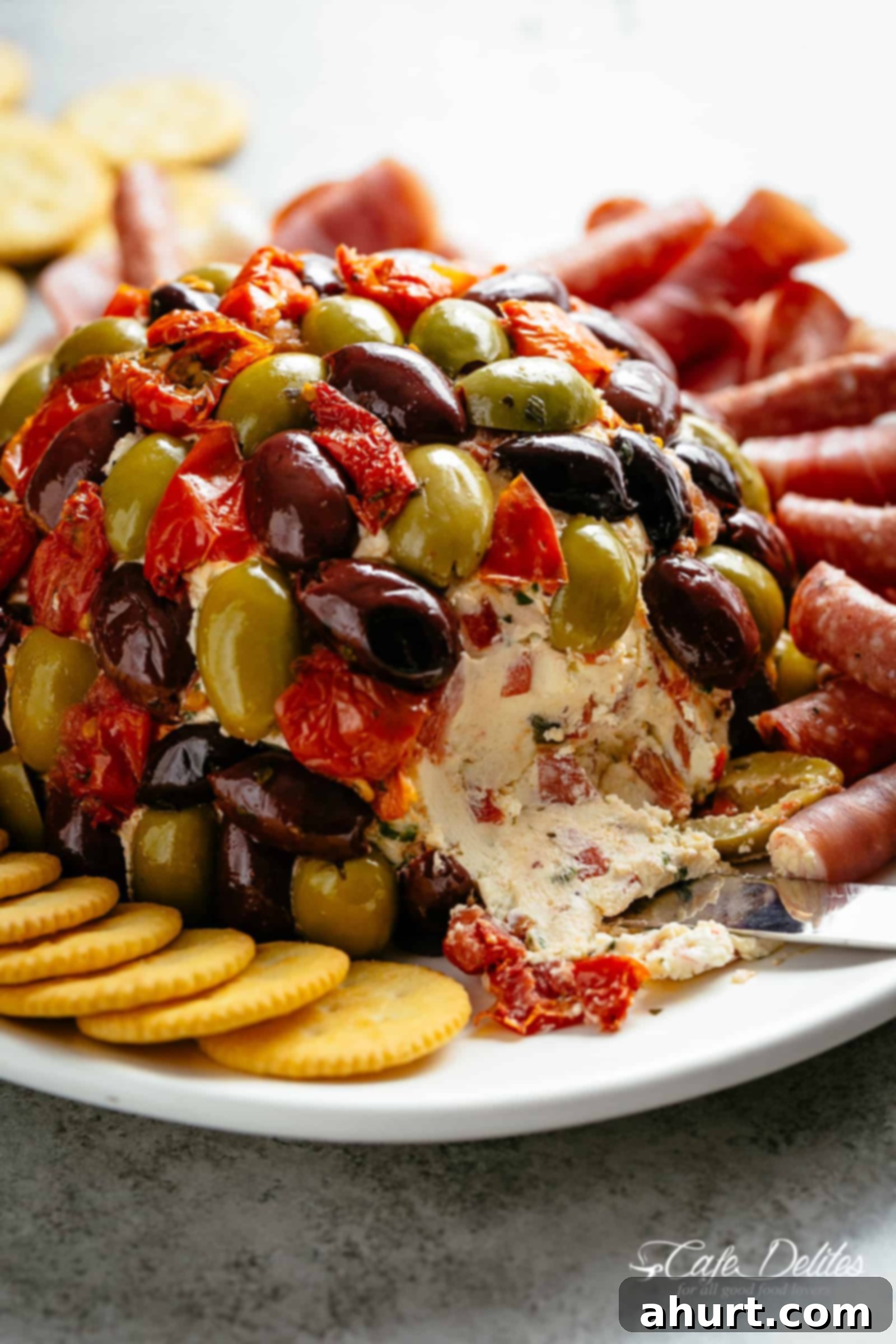 Irresistible Cheese Ball Antipasto 2 Delicious Antipasto Cheese Ball on a platter with crackers and meats