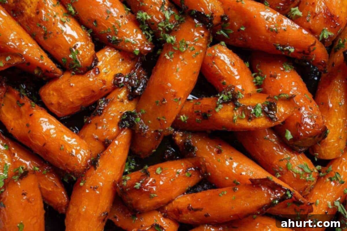 Golden Honey Garlic Butter Carrots 11 Close-up image of the carrots sprinkled with salt, pepper, and parsley, ready to be served.