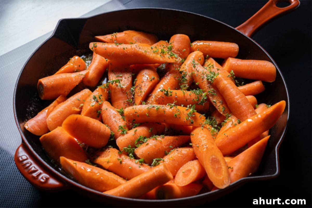Golden Honey Garlic Butter Carrots 7 Image of carrots being placed in a pan and tossed in the thickening sauce.