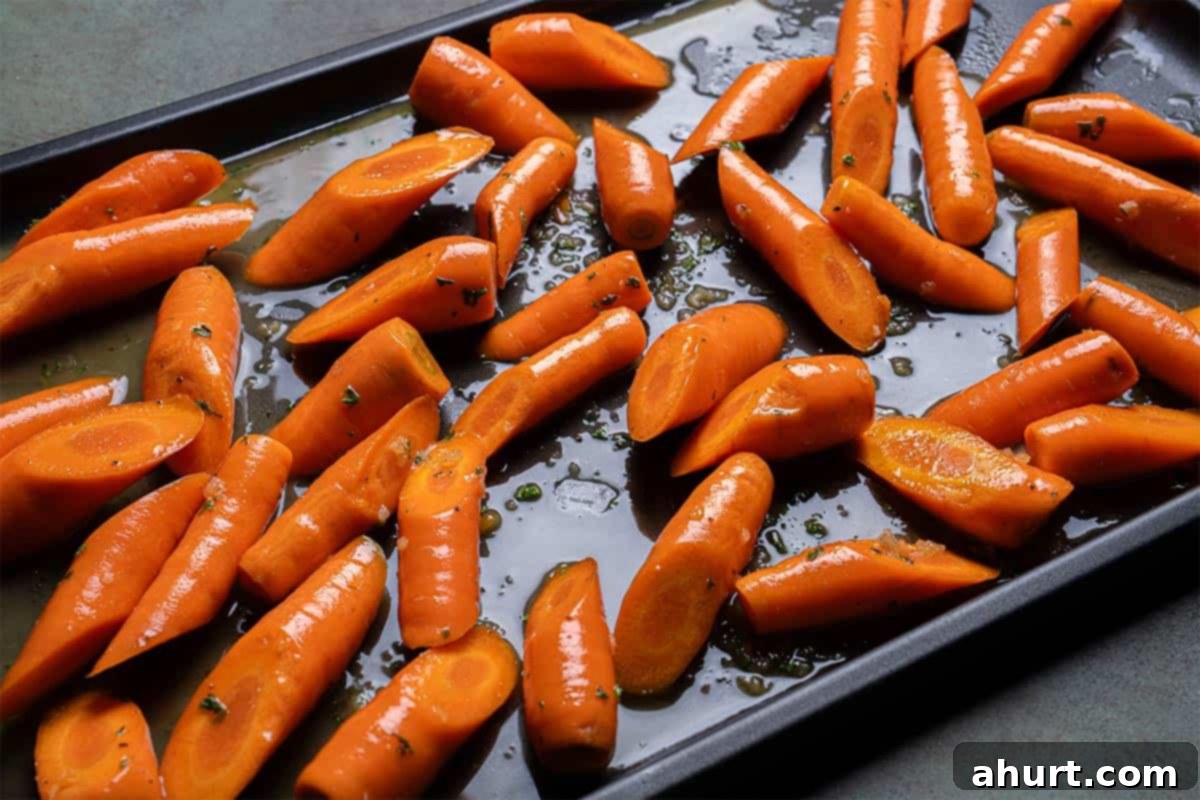 Golden Honey Garlic Butter Carrots 8 Image of carrots being laid on a baking tray, ready to be put into the oven.