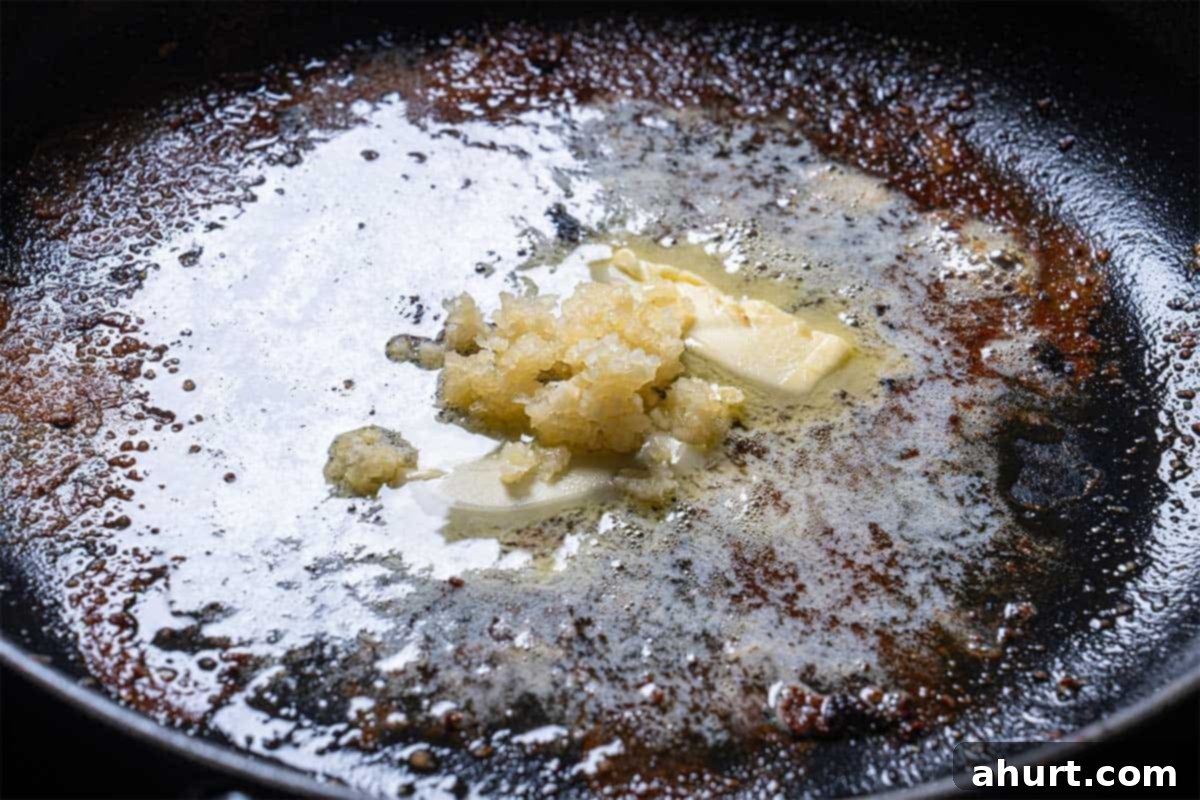 Pan-Seared Golden Garlic Butter Scallops 5 Image of the frying pan with salt and pepper.