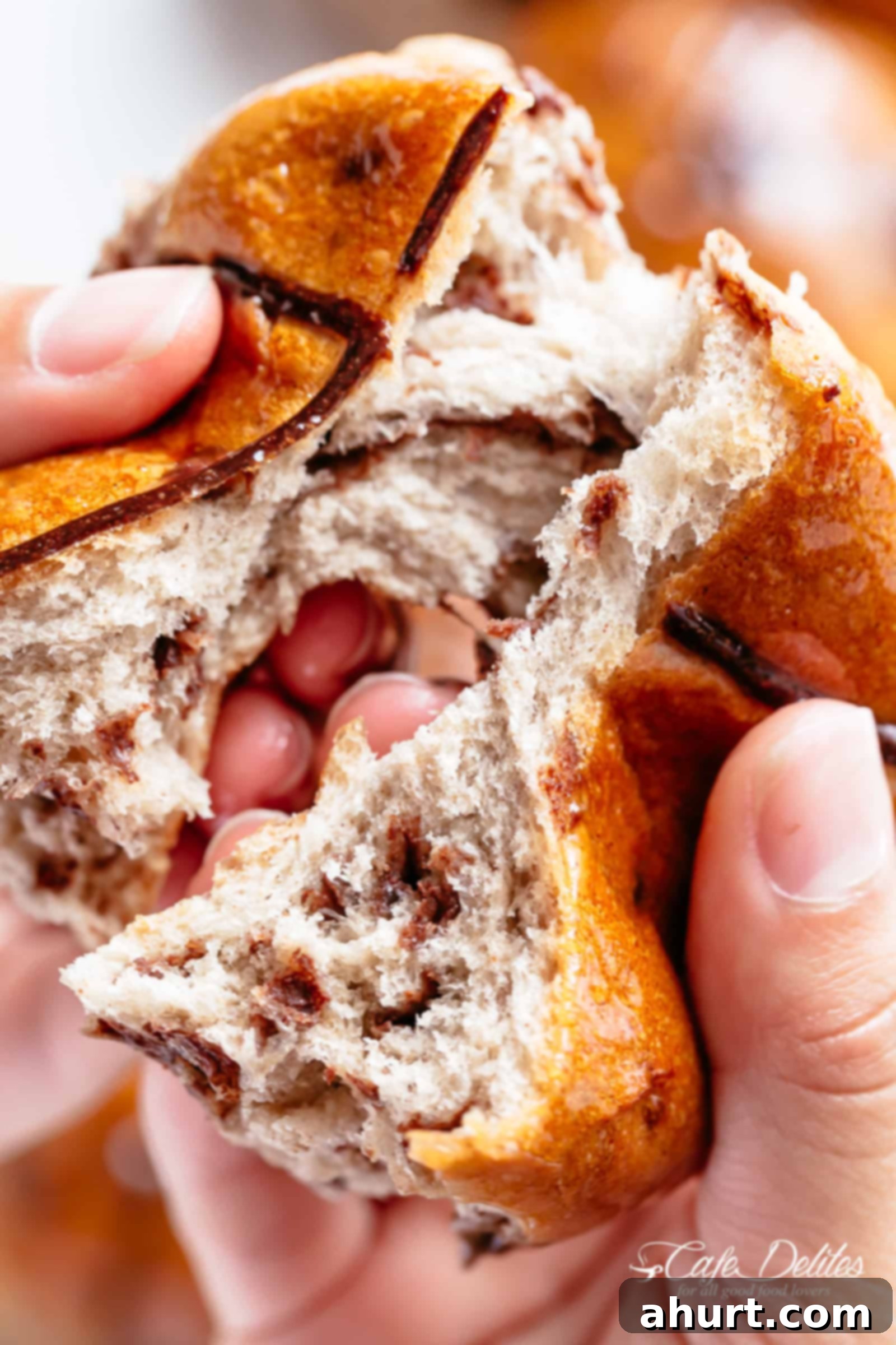 Fluffy and fragrant homemade hot cross buns filled with melted chocolate chips 