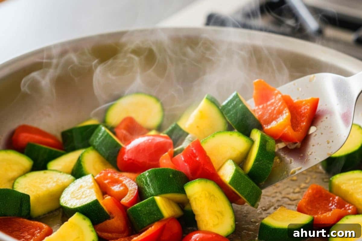 Sticky Honey Soy Chicken 7 Stir-frying the zucchini and bell pepper.