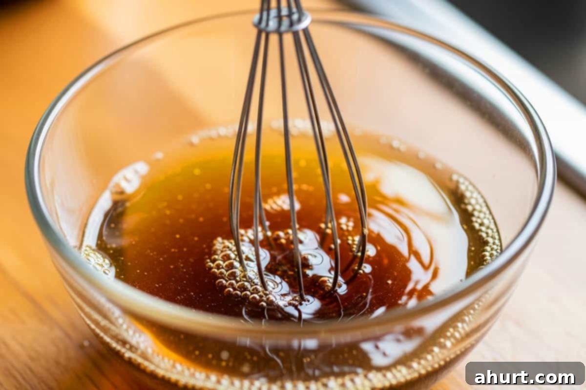 Sticky Honey Soy Chicken 9 Chicken broth, soy sauce, and honey whisked together in a small bowl.