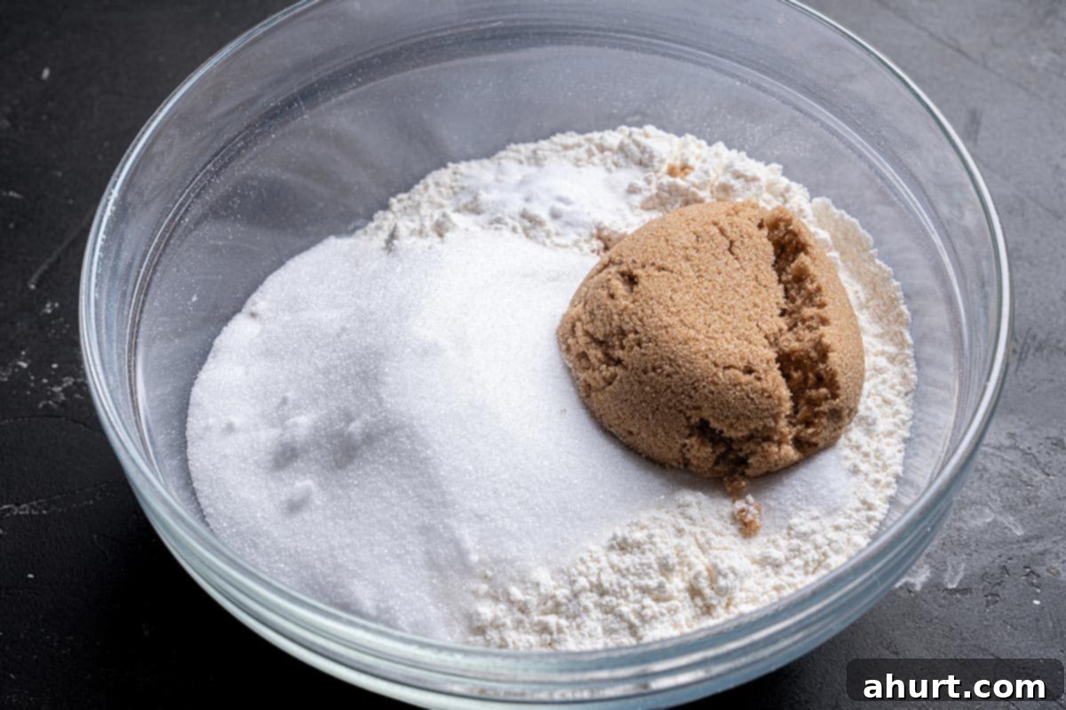The Ultimate Chocolate Chip Banana Bread 5 flour, sugars, baking soda, salt, and cinnamon mixed in a bowl