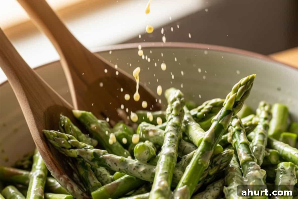 Effortless Lemon Garlic Asparagus 5 Pouring half of the dressing over the spears.