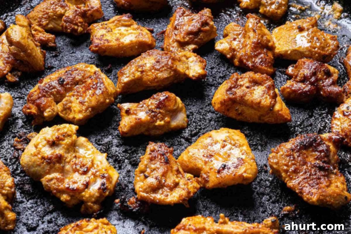 Rich and Creamy Chicken Tikka Masala 5 seared chicken in a large black skillet not overcrowded