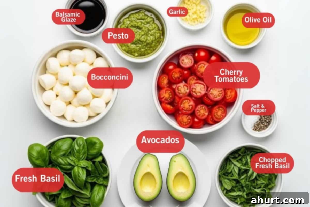 Caprese Avocado Boats 2 Flat lay photo of ingredients for Caprese Stuffed Avocado: balsamic glaze, pesto, minced garlic, olive oil, bocconcini (mozzarella balls), cherry tomatoes, salt and pepper, chopped fresh basil, and ripe avocados.
