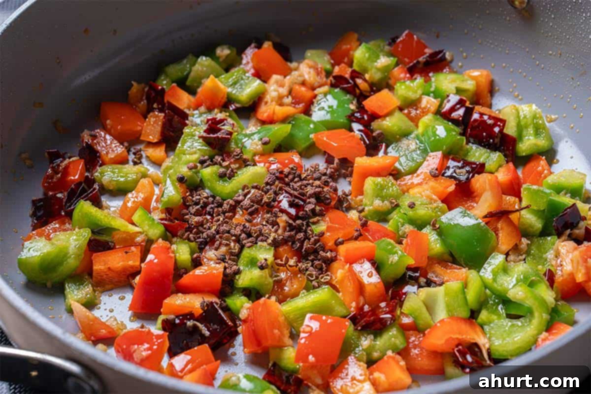 Kung Pao Chicken 6 garlic, ginger, chili diced peppers (capsicums) and Sichuan peppercorns in a wok cooking