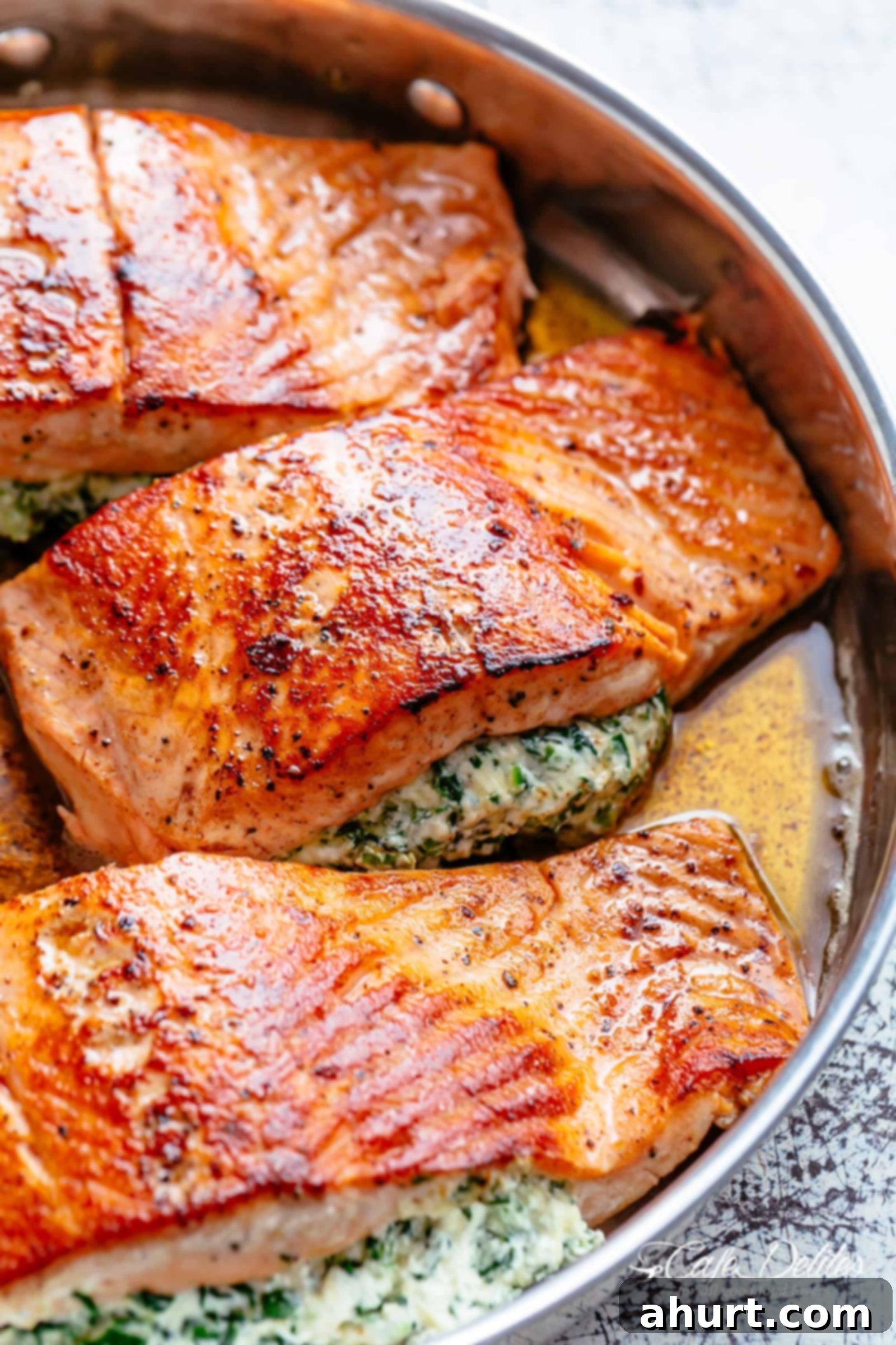Creamy Spinach Stuffed Salmon with cream cheese, spinach, parmesan cheese and garlic! | cafedelites.com Creamy Spinach Stuffed Salmon in garlic butter is a new delicious way to enjoy salmon! Filled with cream cheese, spinach, parmesan cheese and garlic, this salmon beats than anything found in a restaurant.