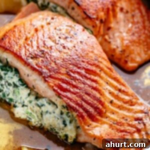 Decadent Garlic Butter Salmon Stuffed with Creamy Spinach 3 Creamy Spinach Stuffed Salmon in garlic butter is a new delicious way to enjoy salmon! Filled with cream cheese, spinach, parmesan cheese and garlic, this salmon beats than anything found in a restaurant.