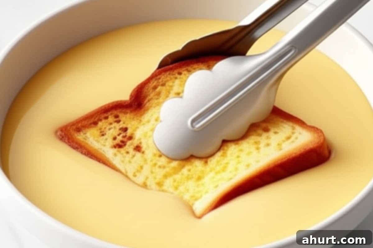 French Toast Perfection 6 Step 3: Dipping a slice of brioche bread into the French toast egg mixture.