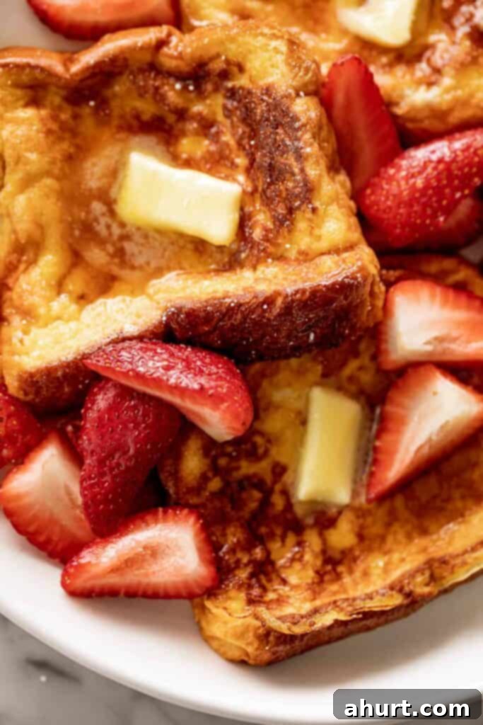 French Toast Perfection 8 French Toast with maple syrup, butter and strawberries.
