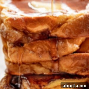 French Toast Perfection 9 Side view image of The Best French Toast drizzled with maple syrup.