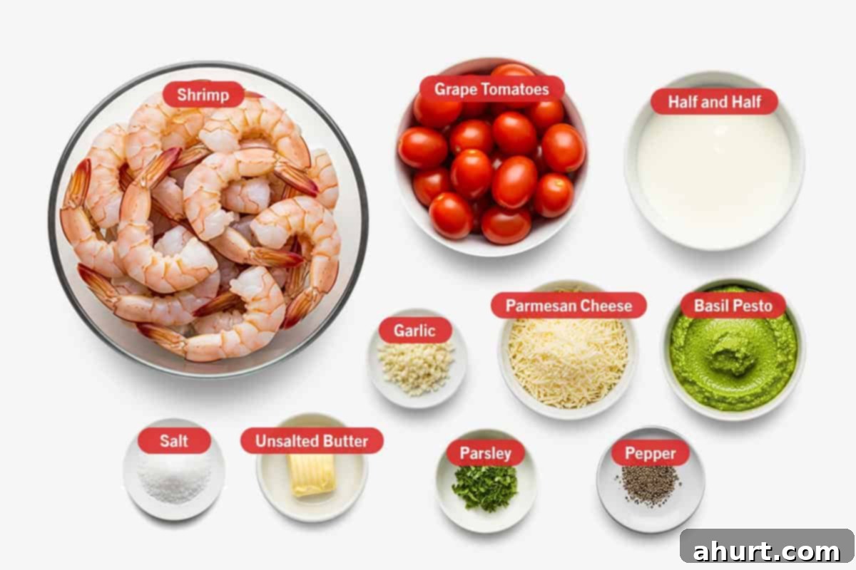 Creamy Pesto Alfredo Shrimp 2 Top shot of ingredients: Shrimp, grape tomatoes, half and half, garlic, parmesan cheese, basil pesto, salt, unsalted butter, parsley, and pepper.