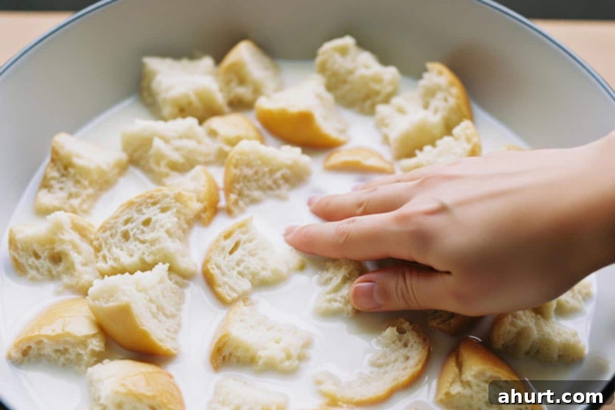 Perfect Homemade Meatloaf 3 Soaking the bread in milk in a large bowl, pressing it down gently to absorb the liquid.