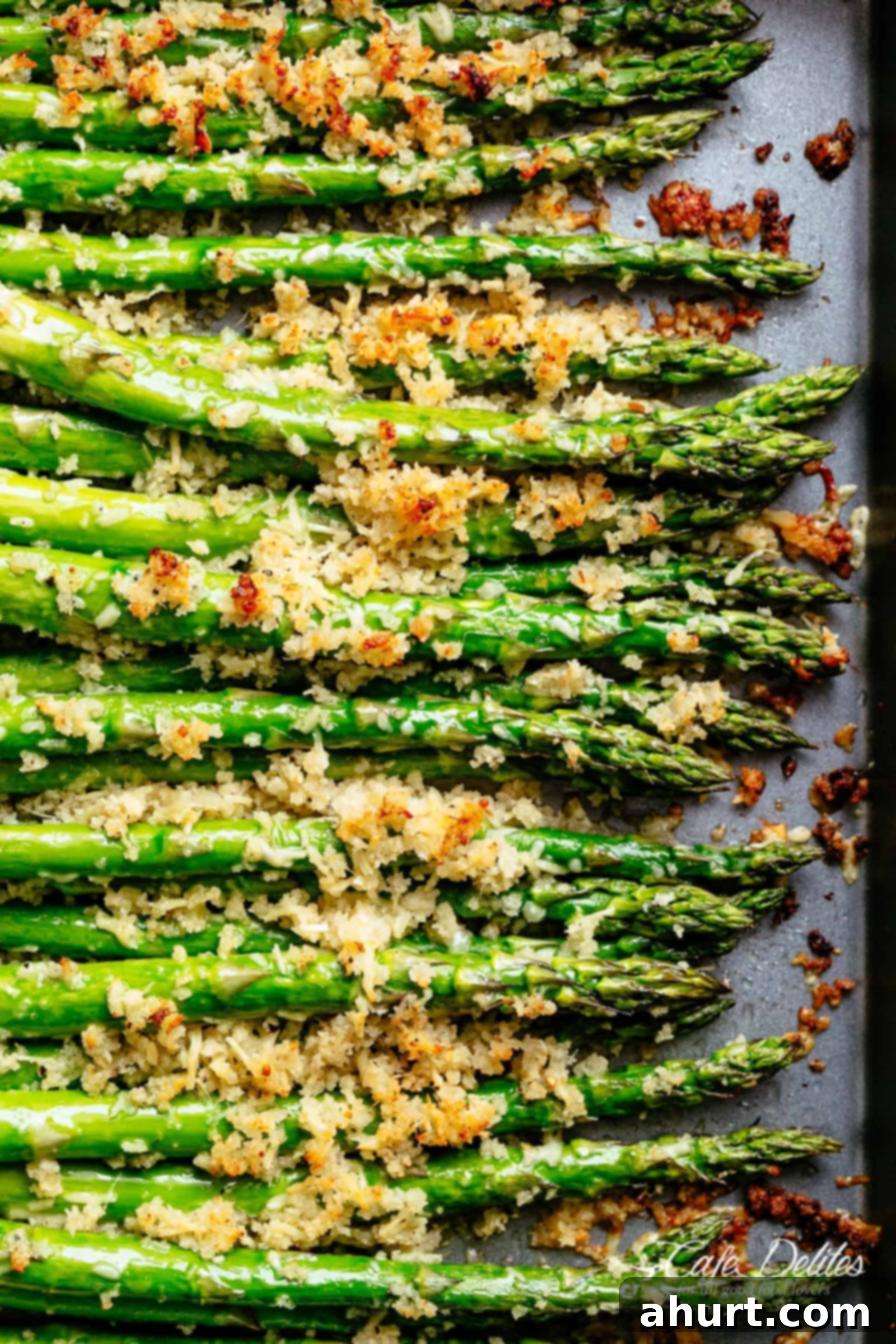 Garlic Butter Asparagus with Crispy Parmesan Topping | cafedelites.com Crispy Garlic Butter Asparagus with Parmesan topping, freshly roasted on a tray.