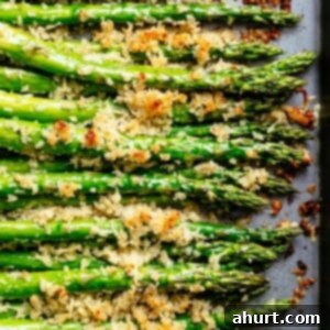 Golden Crispy Parmesan Asparagus in Garlic Butter 2 Garlic Butter Asparagus with Crispy Parmesan lying on a tray