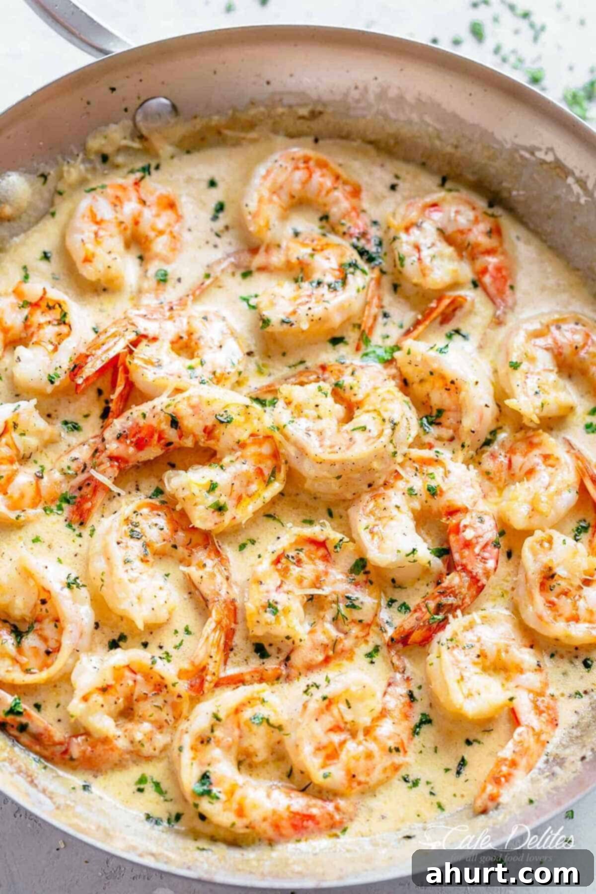 Creamy Garlic Parmesan Shrimp | cafedelites.com Close-up shot of succulent shrimp covered in a creamy garlic sauce with parmesan, garnished with fresh parsley.