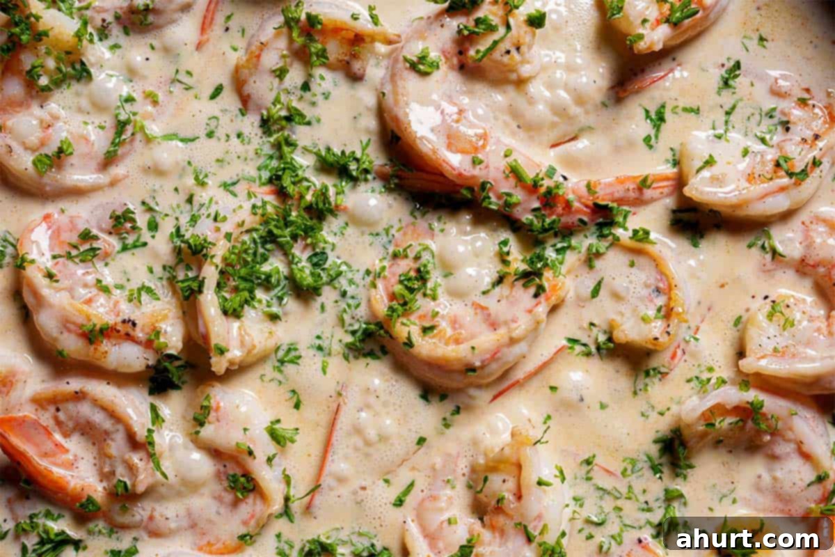 Luscious Low Carb Creamy Garlic Parmesan Shrimp 8 Close-up image of the shrimp in sauce, sprinkled with parsley.