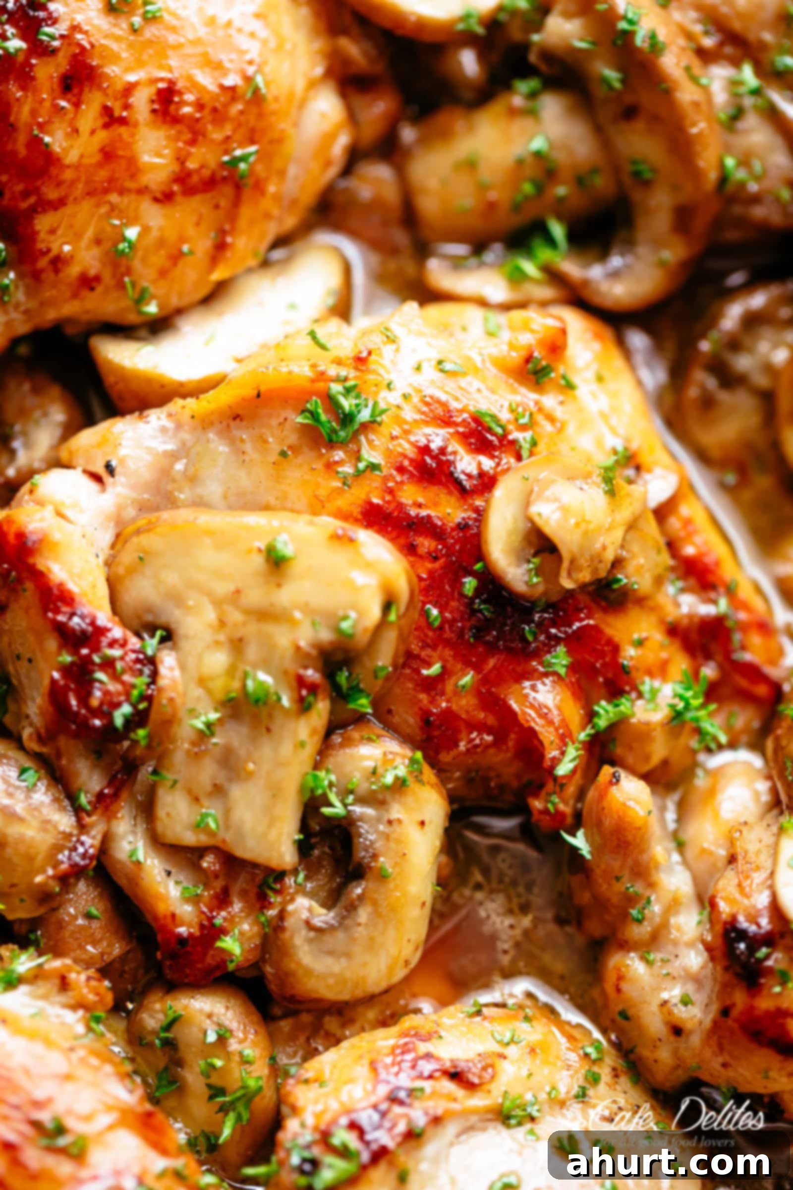 Garlic Mushroom Chicken Thighs | cafedelites.com Golden seared Garlic Mushroom Chicken Thighs in a delicious, buttery sauce with a sprinkle of herbs. A close-up of the perfectly cooked chicken and rich sauce.