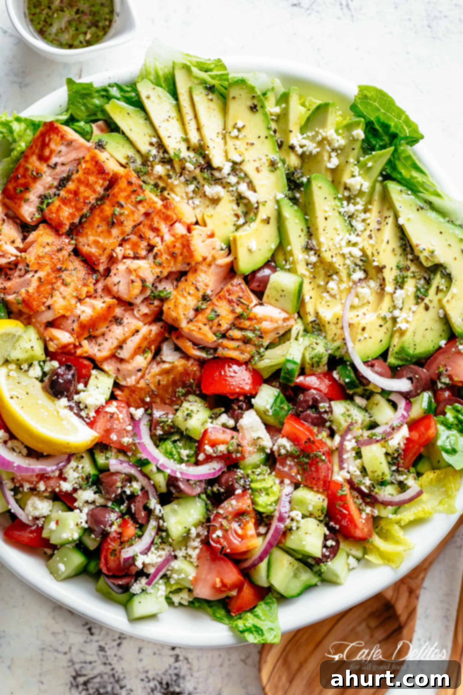 Avocado Salmon Salad with an incredible lemon herb Mediterranean dressing! | cafedelites.com Avocado Salmon Salad with an incredible lemon herb Mediterranean dressing! Loaded with cucumber, olives, tomatoes and feta cheese on a plate