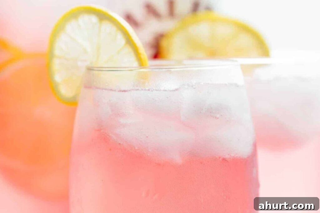 Pink Vodka Lemonade Perfection 4 Step 2: Adding lemonade or Sprite to the mixed vodka base and gently stirring before serving.