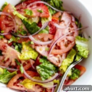 No-Fuss Tomato Salad 6 Close-up of Easy Tomato Salad with Lemon Parmesan Vinaigrette in a serving bowl