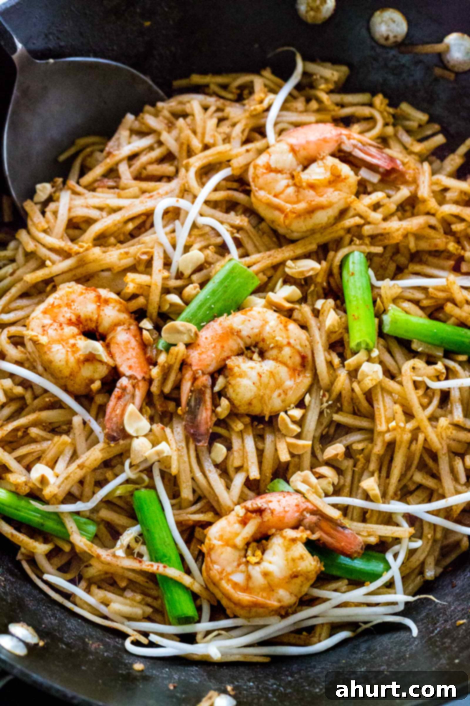 Classic Pad Thai 2 Sizzling Pad Thai with chicken and shrimp cooking in a large wok