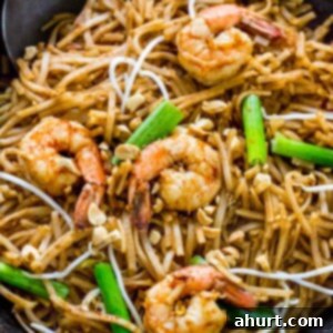 Classic Pad Thai 13 Delicious Pad Thai with chicken and shrimp in a wok, ready to serve