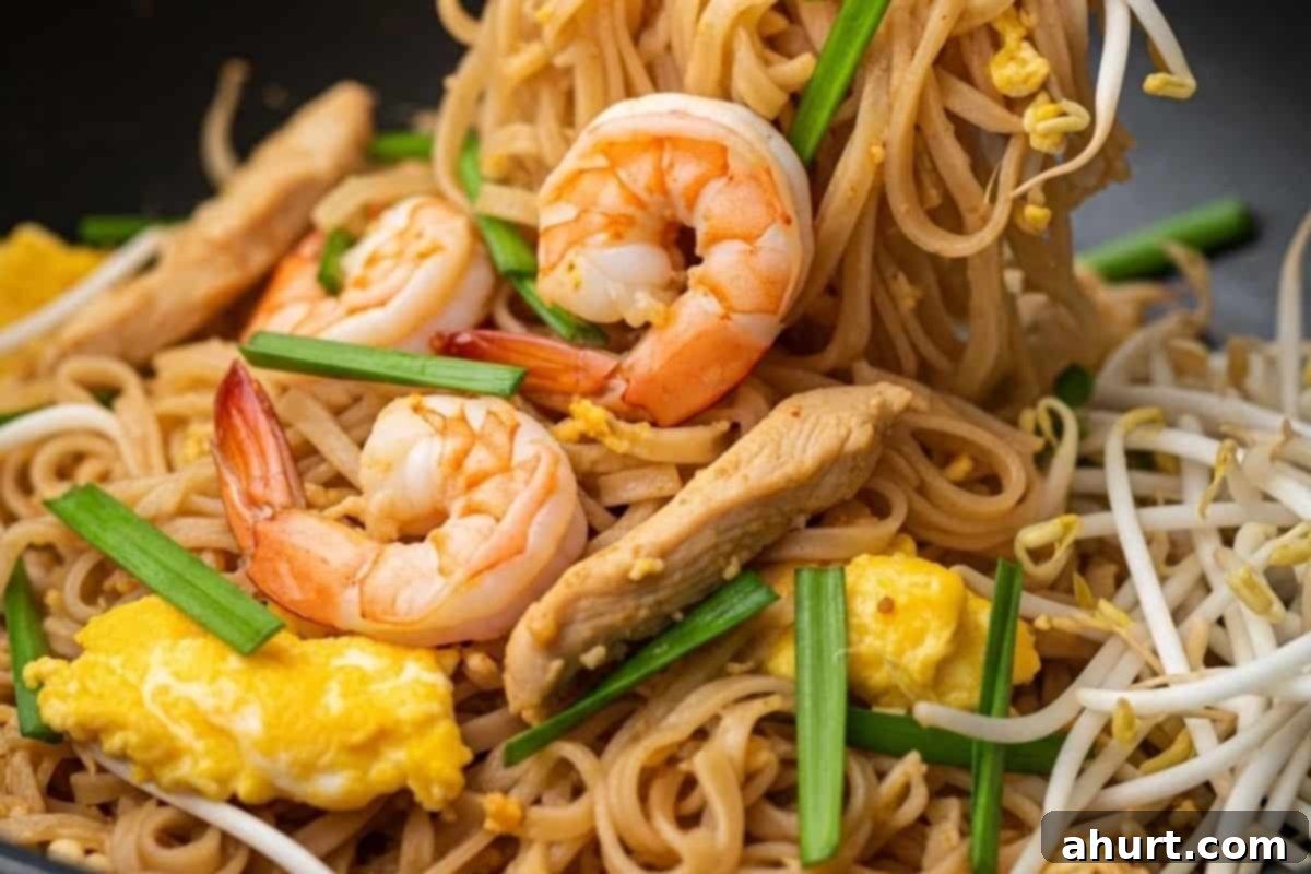 Classic Pad Thai 10 Add green onions and bean sprouts to the Pad Thai, stir-frying briefly until just wilted