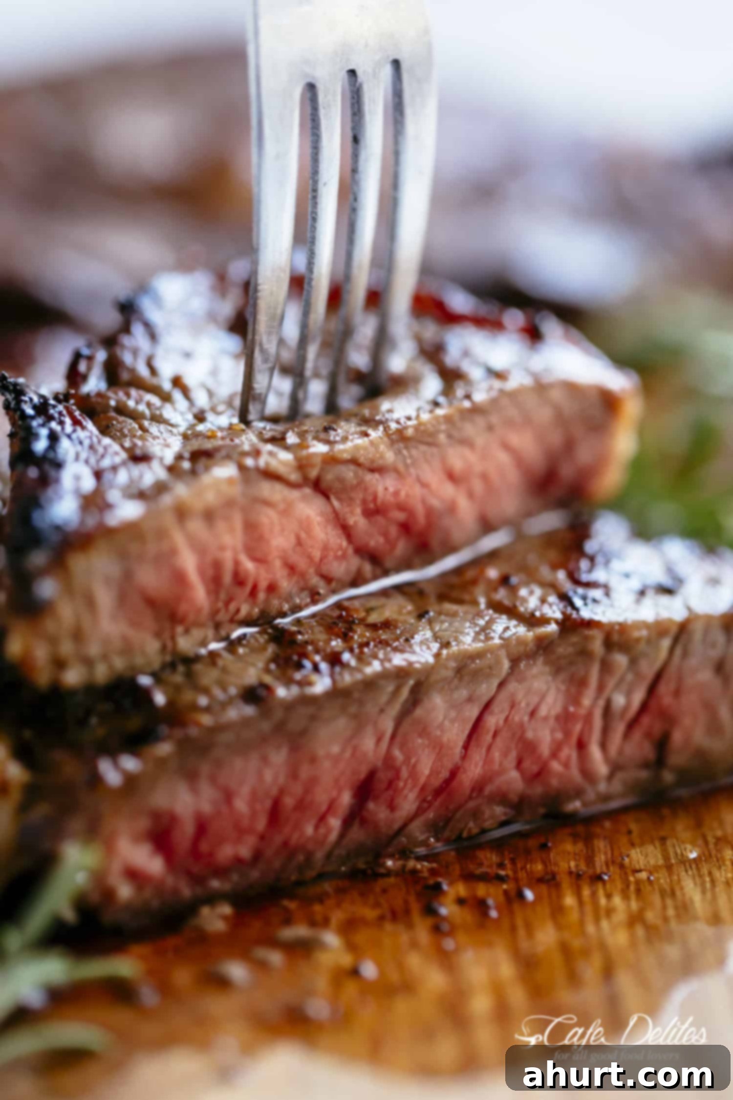 The Steakhouse Masterpiece 3 A fork pierced into a piece of Medium Rare Steak