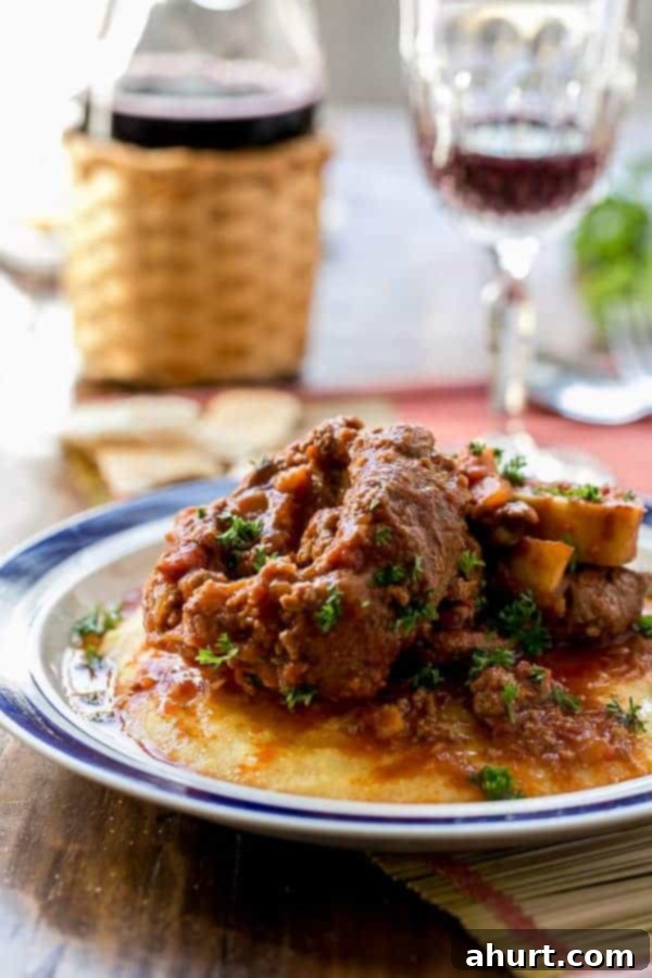 Side view image of Osso Bucco in Red Wine Salsa with Soft Polenta on a plate