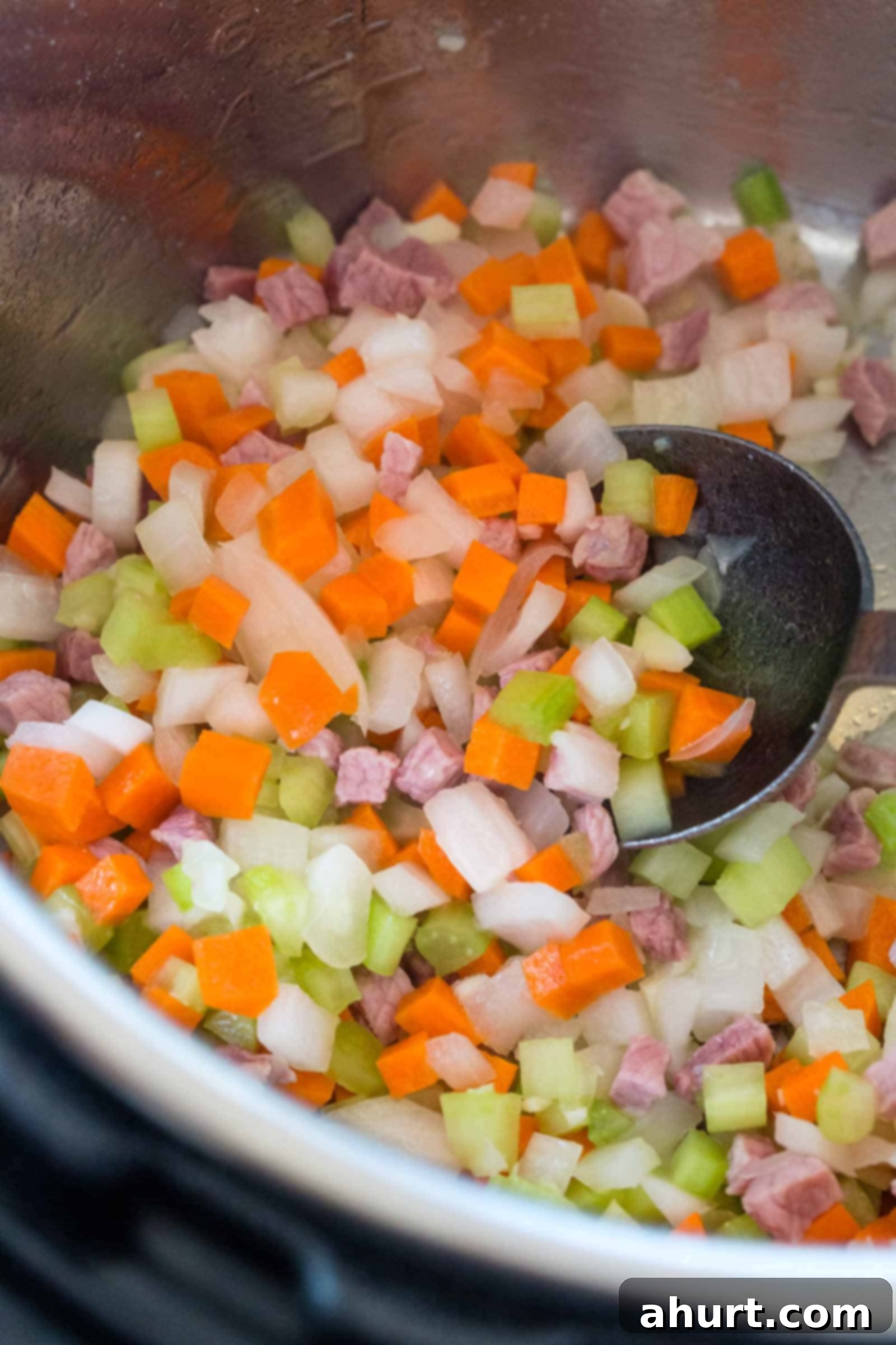 Chopped pancetta, garlic, onions, and carrots cooking in the Instant Pot