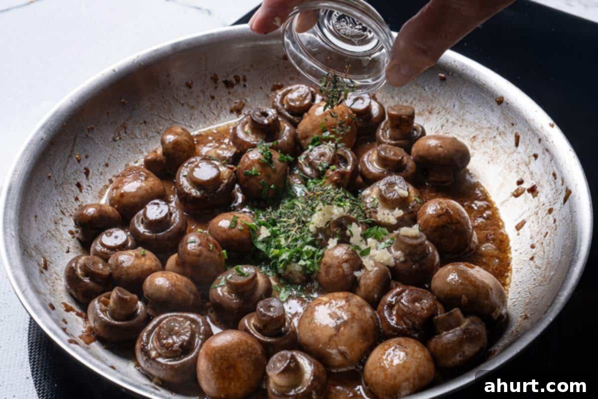 Golden Garlic Butter Mushrooms 7 Image of herbs being added to the pan.