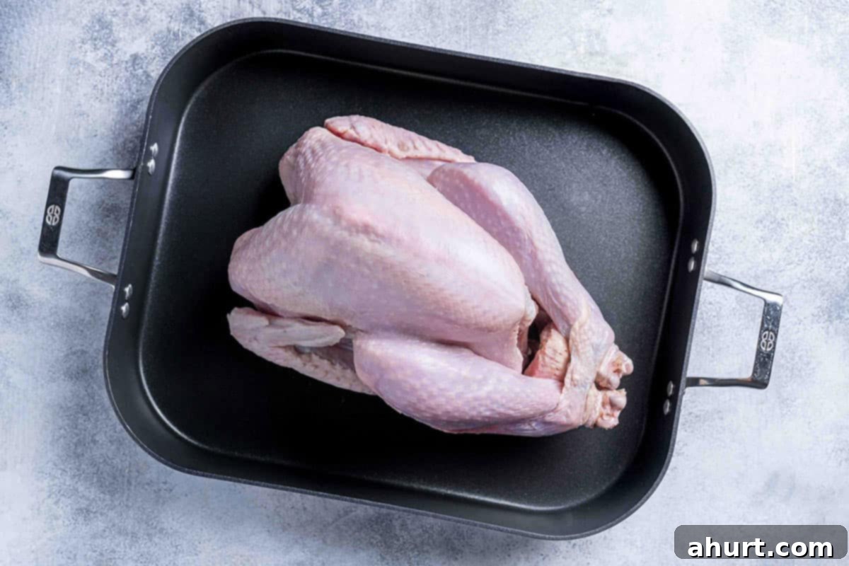 Perfect Herb Butter Roasted Turkey 4 Defrosted Turkey in a cooking tray with giblets and neck removed