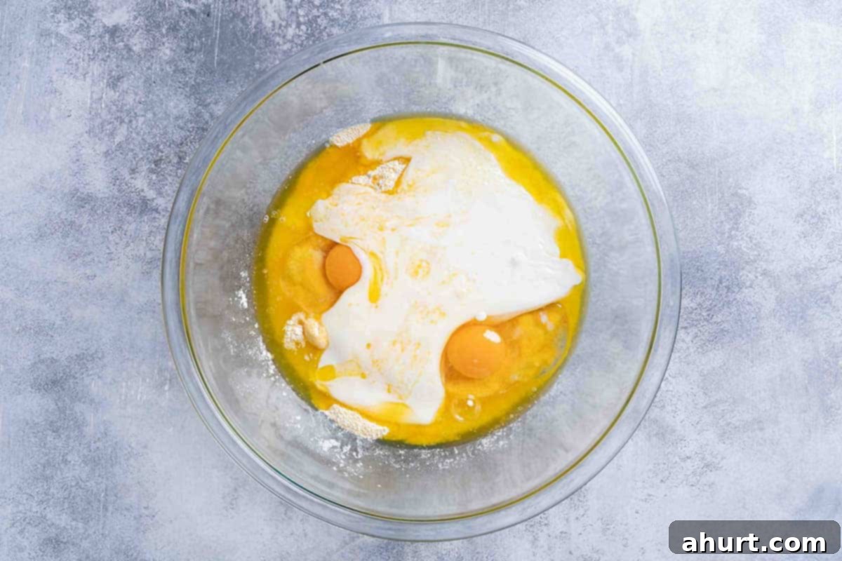 The Ultimate Recipe for Melt-in-Your-Mouth Cornbread 5 A picture showing buttermilk, honey, and eggs in one clear bowl, and melted butter in a separate clear mixing bowl, representing the wet ingredients.