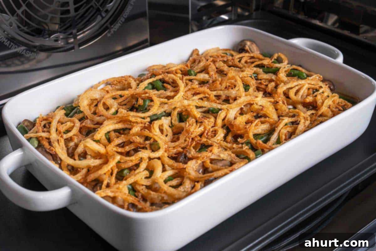 Velvety Green Bean Casserole with a Golden Crunch 11 green bean casserole dish in oven with golden crispy fried onion rings on top