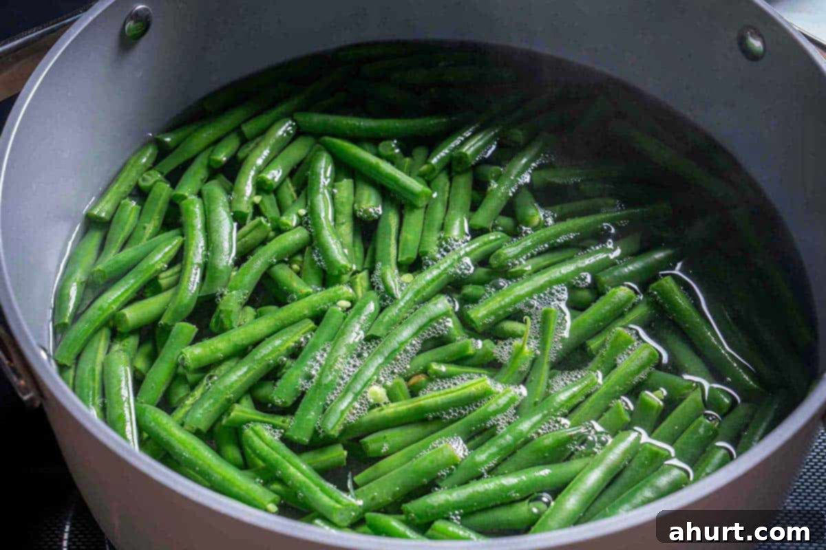 Velvety Green Bean Casserole with a Golden Crunch 4 Green Beans in a pot simmering