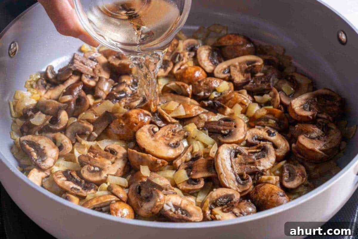 Velvety Green Bean Casserole with a Golden Crunch 6 wine being poured into pan of mushroom soup